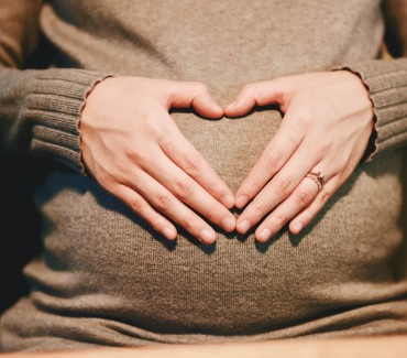 heart hands on pregnant belly